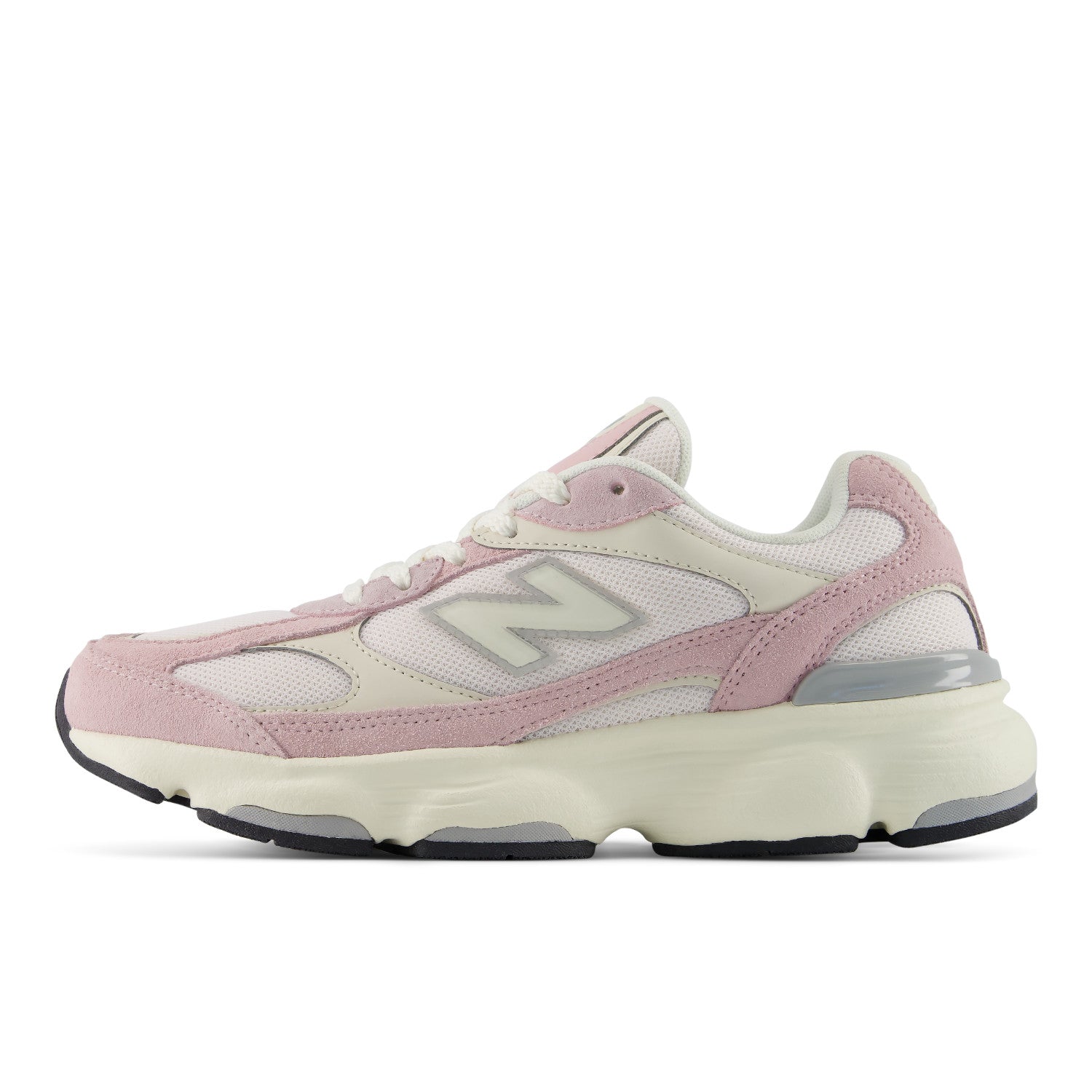 A New Balance chunky sneaker in pastel pink and cream, featuring a thick cream midsole, light pink overlays, and the signature grey 'N' logo on the side.