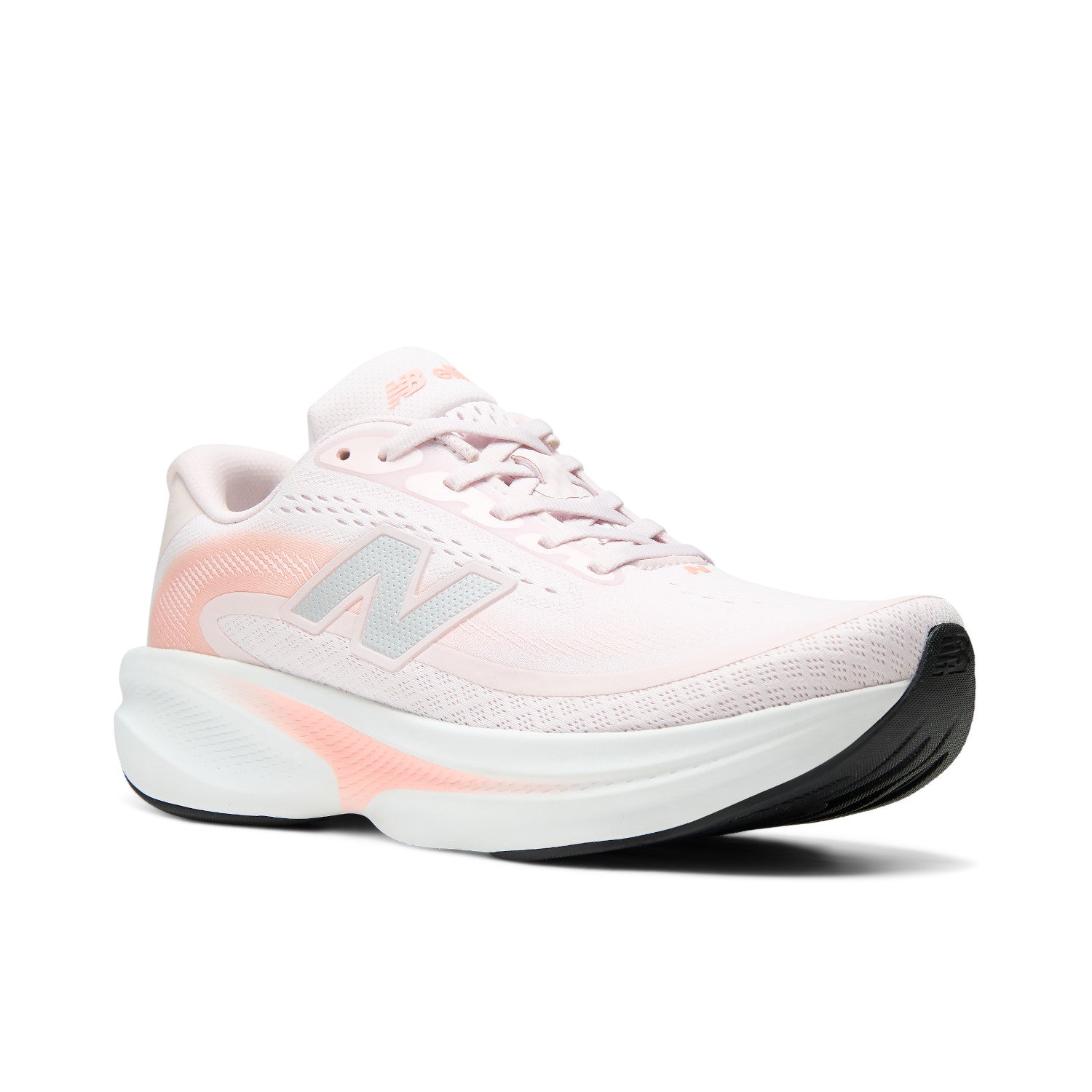A New Balance running shoe in light pink and white with a black outsole, shown from a side profile on a white background.