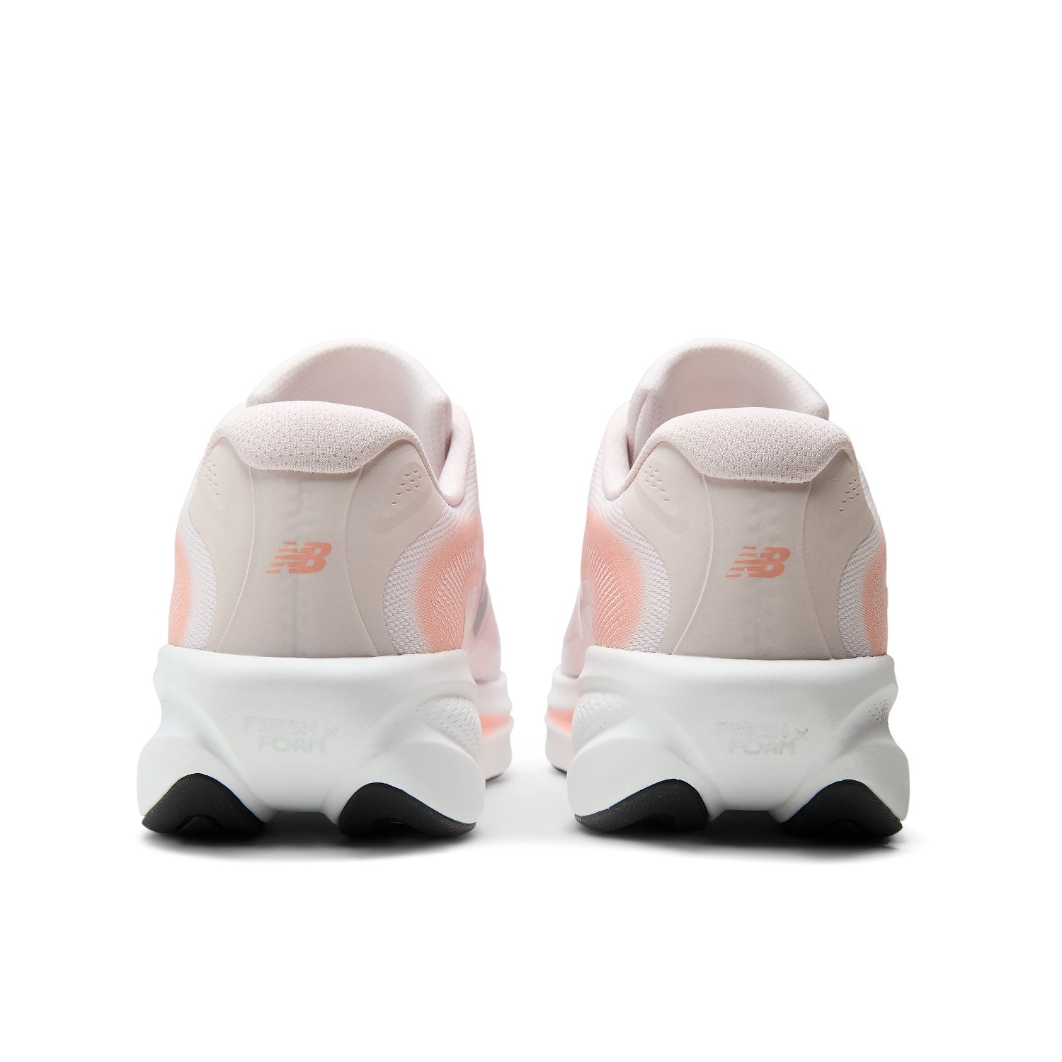 A pair of New Balance running shoes shown from the back, featuring a light pink and white upper with peach accents and a chunky white midsole.