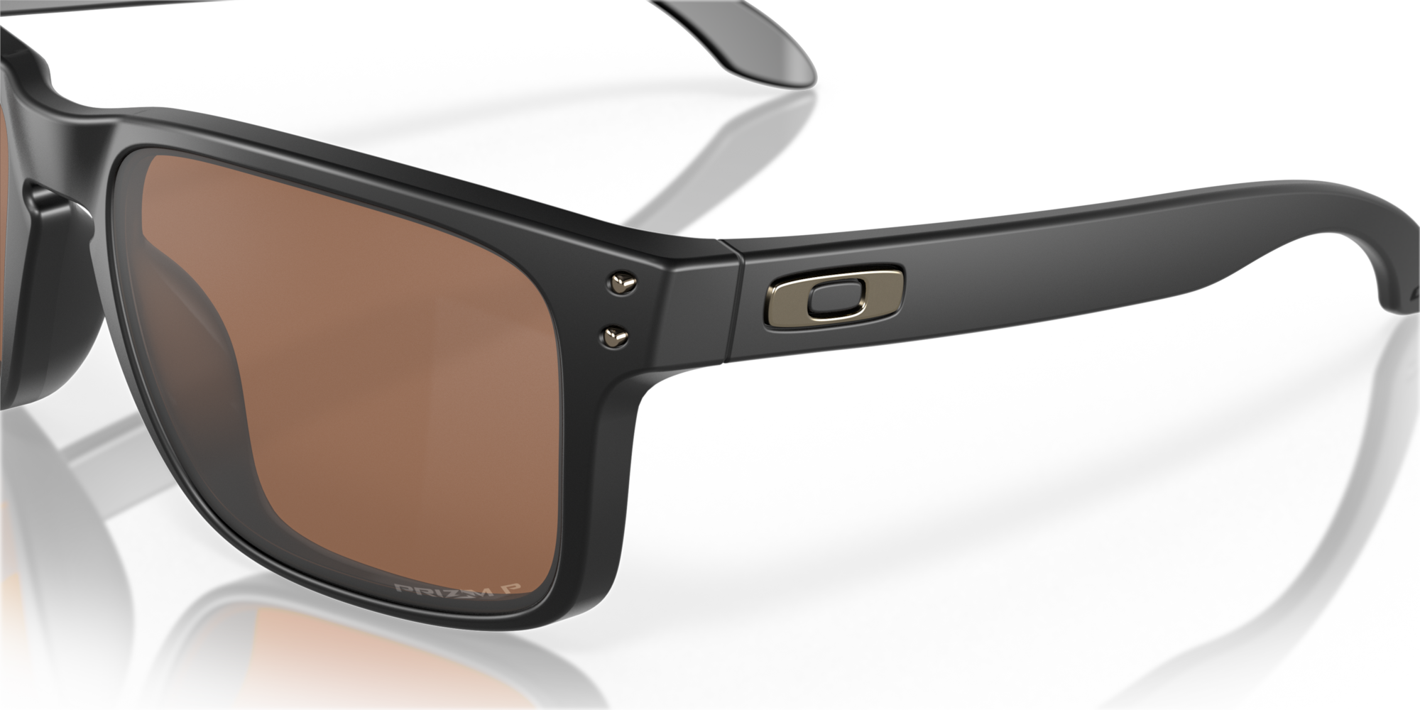 Black sunglasses with brown lenses on a reflective surface