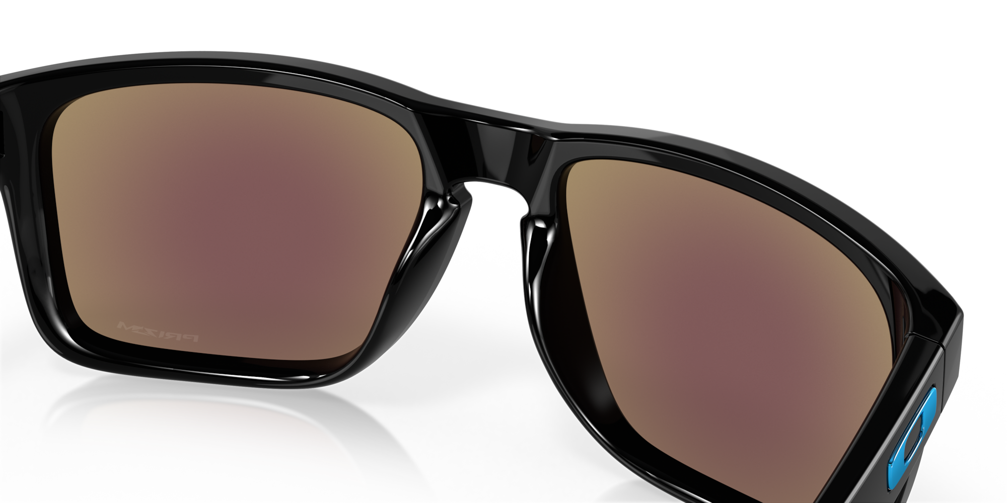 Black sunglasses with brown lenses on a reflective black surface