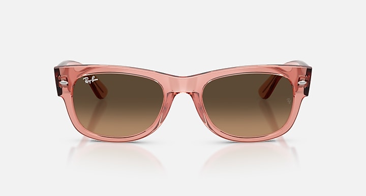 Pink sunglasses with brown lenses on a white background