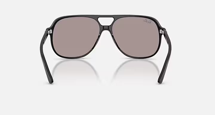 Sunglasses with black frame and reflective lenses on a white background
