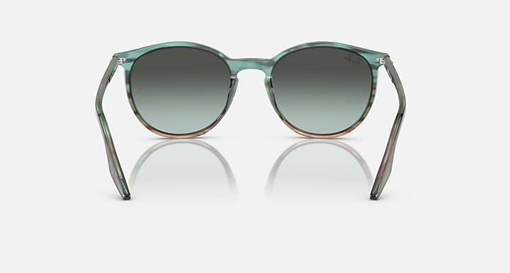 Sunglasses with green gradient lenses on a white background