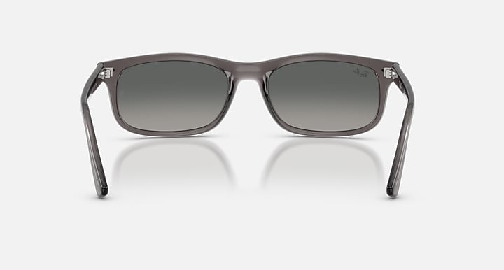 Gray sunglasses with a reflective surface on a white background
