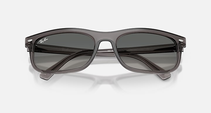 Sunglasses with dark lenses and gray frame on a white background