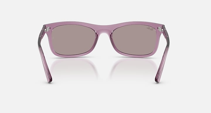 Purple sunglasses with dark lenses on a white background