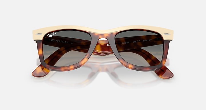 Tortoiseshell sunglasses with beige frame on a white background