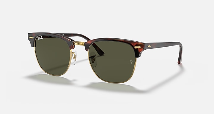 Sunglasses with tortoiseshell frame and green lenses on a white background