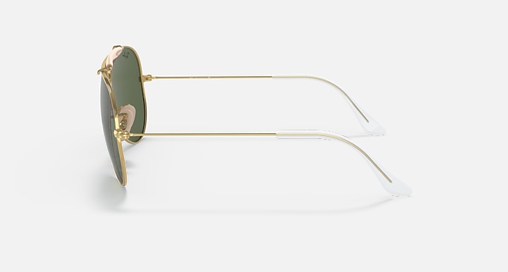 Gold-framed sunglasses with green lenses on a white background