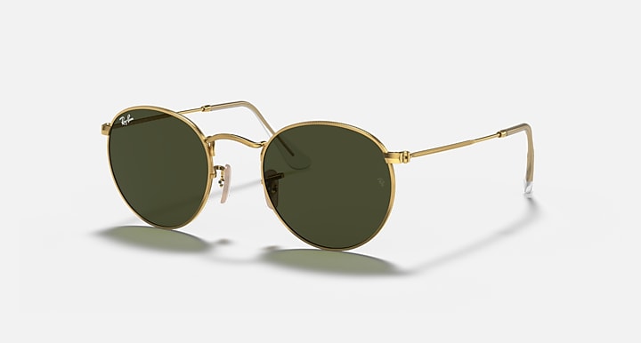 Gold-framed sunglasses with dark lenses on a white background