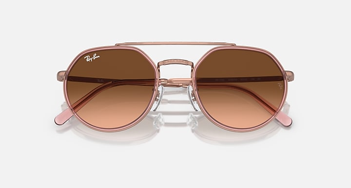Round sunglasses with rose gold frame and brown gradient lenses on a white background