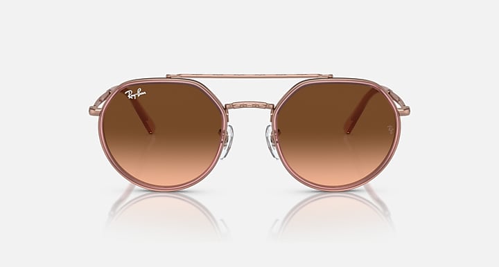 Round sunglasses with brown gradient lenses on a white background
