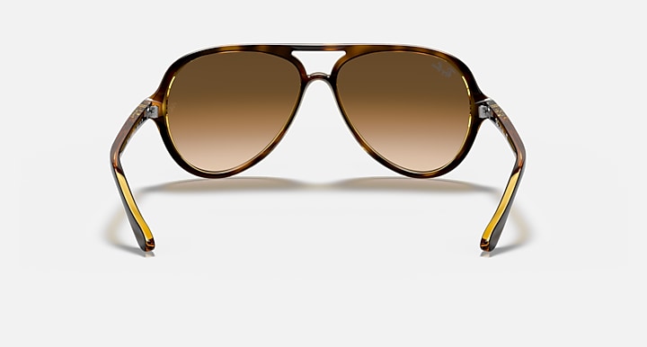 Aviator sunglasses with brown gradient lenses on a white background