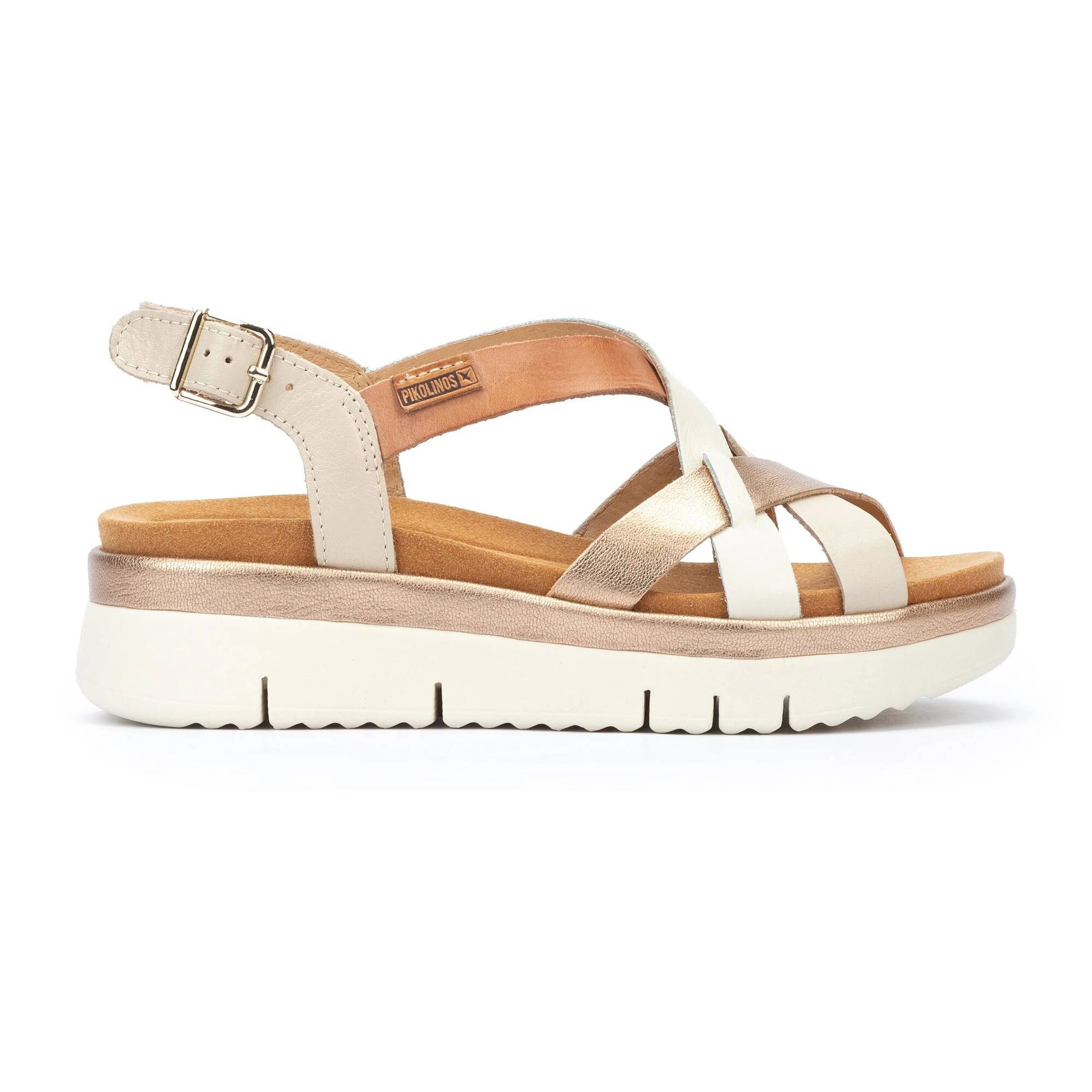 White sandal with brown sole on a white background
