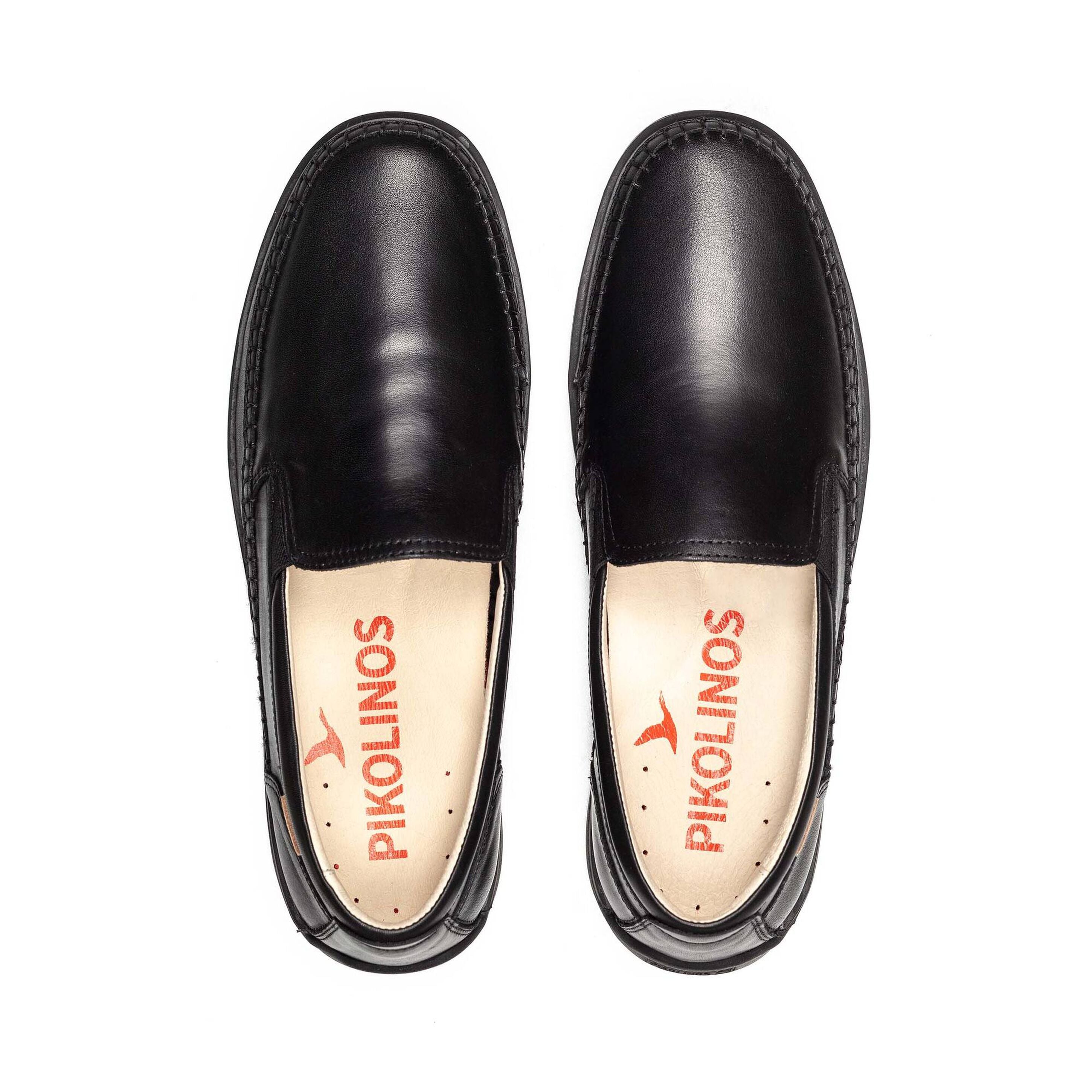 Black leather loafers with visible brand logo on a white background