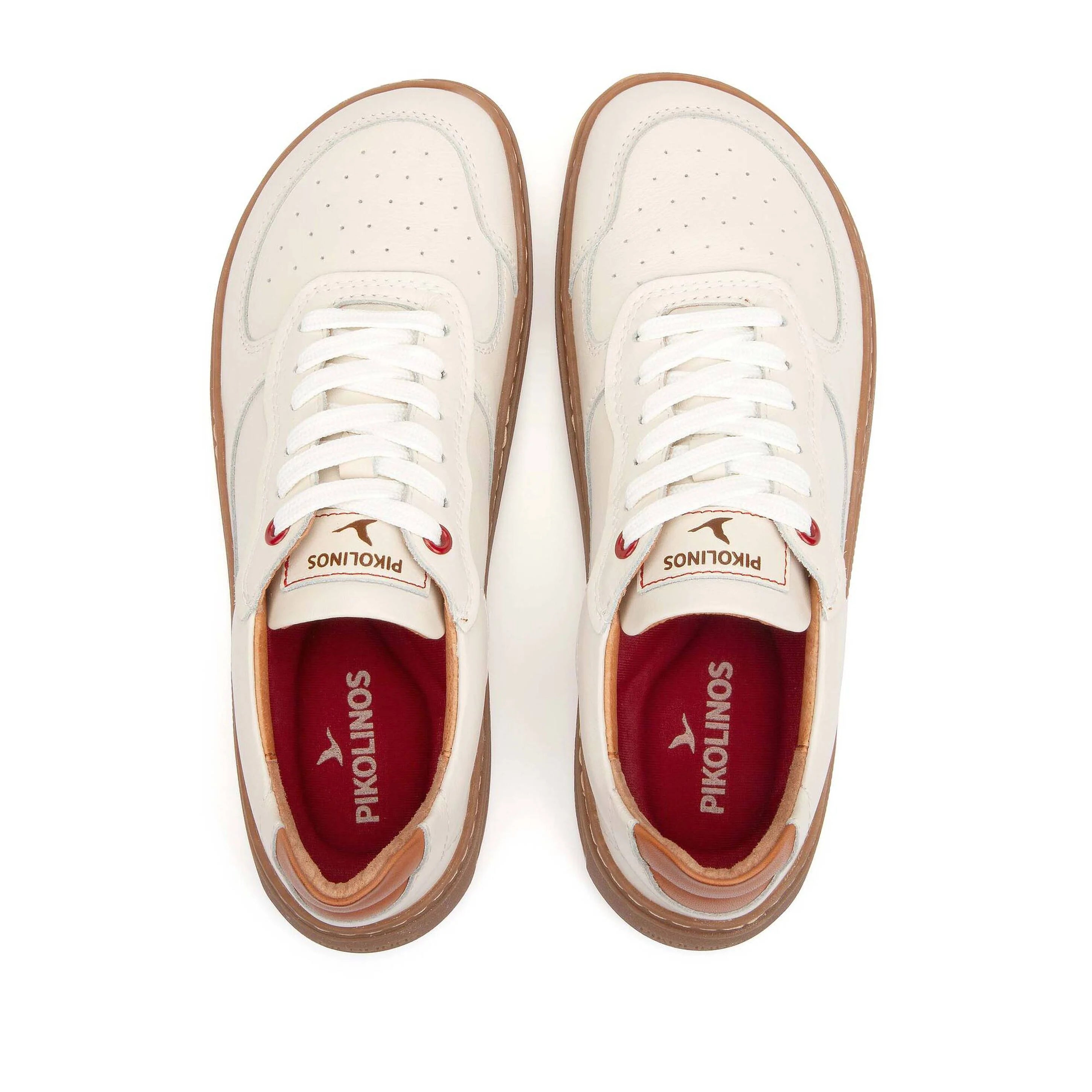 White sneakers with red soles and visible brand logo on a white background