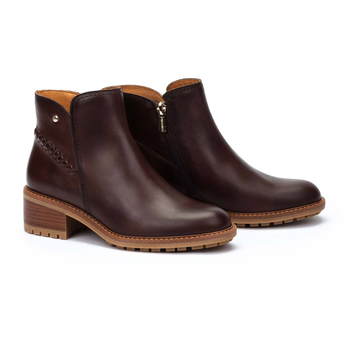 Pair of brown leather ankle boots on a white background