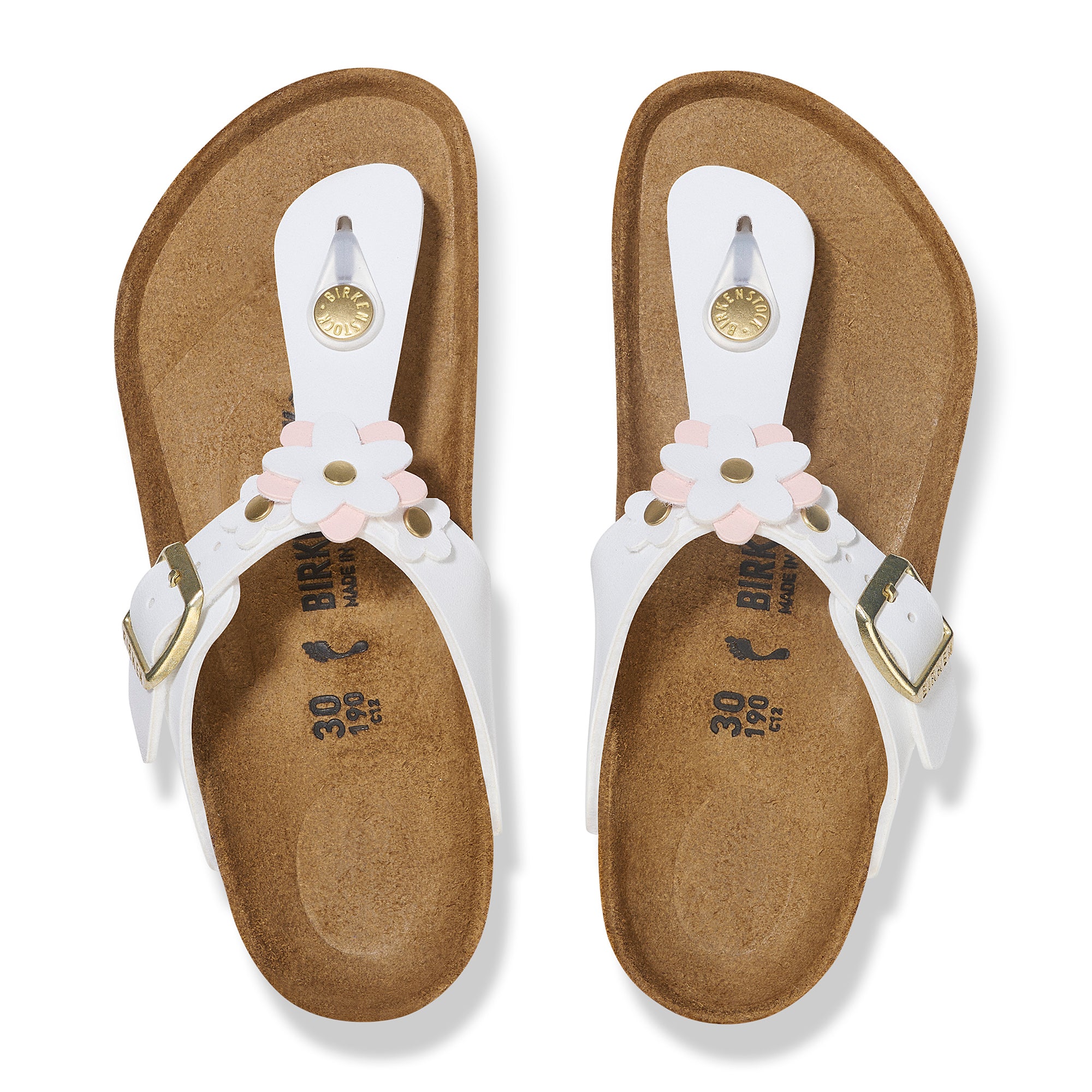 Pair of sandals with white straps and floral decorations on a white background