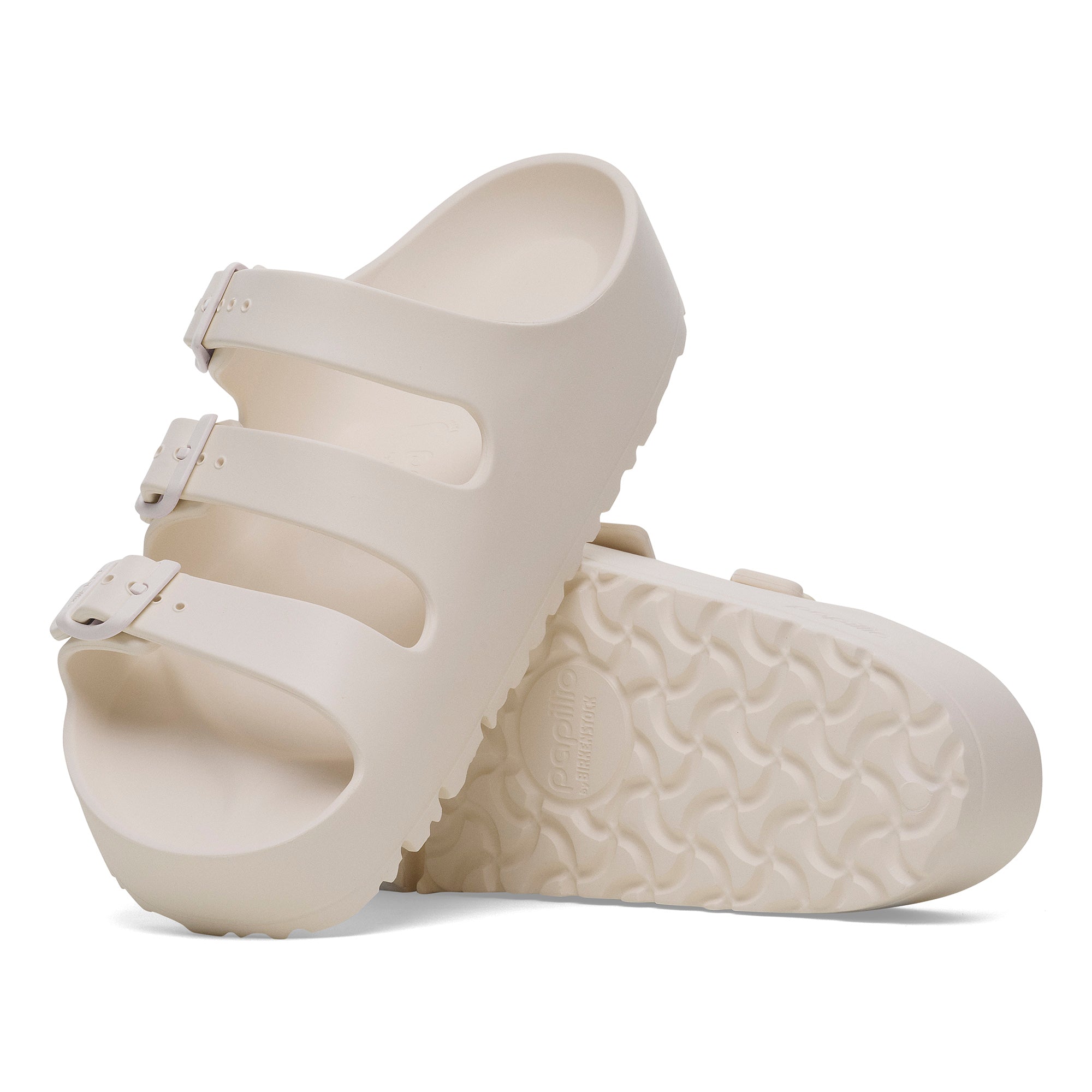 White sandal with textured sole on a white background