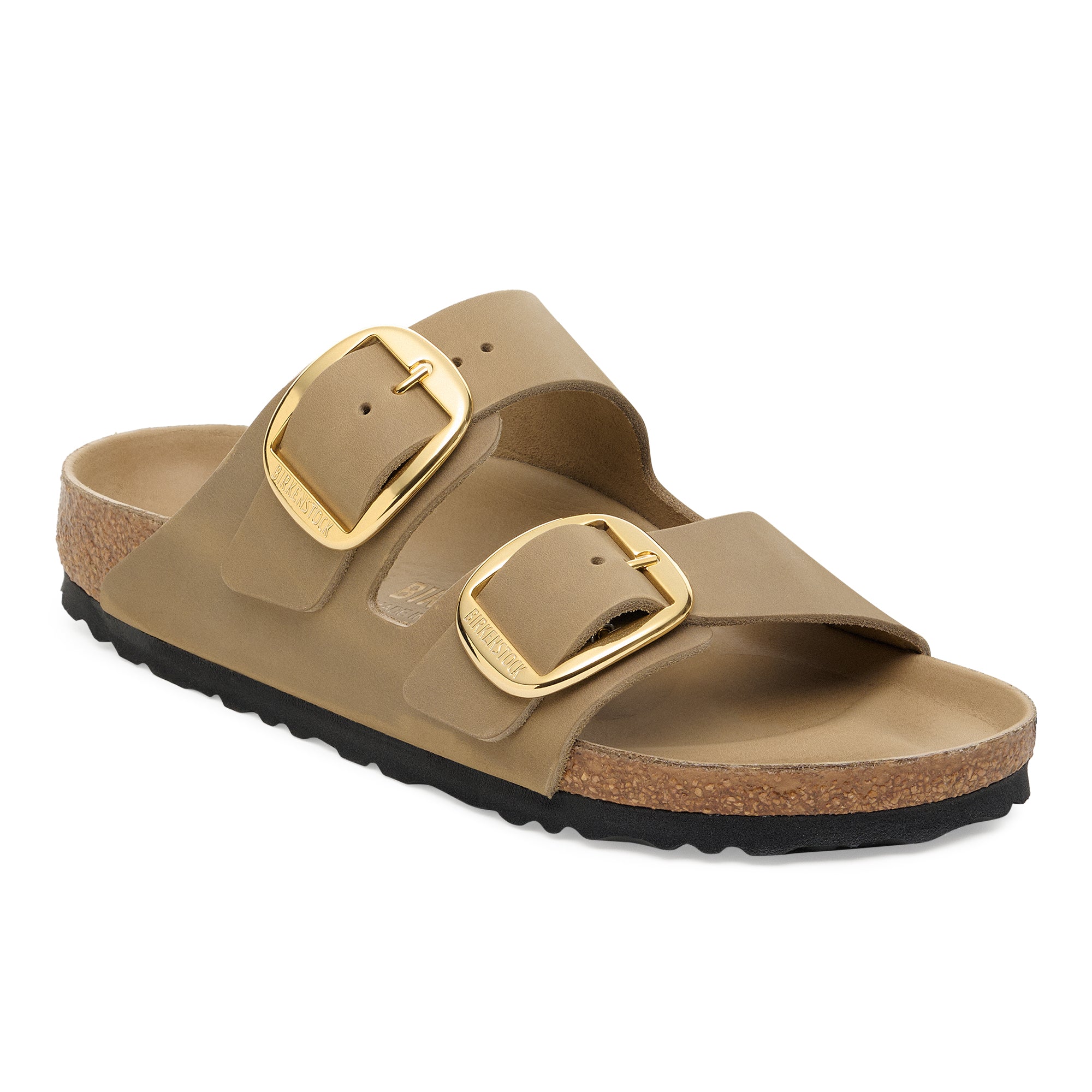 Tan sandal with gold buckles on a white background