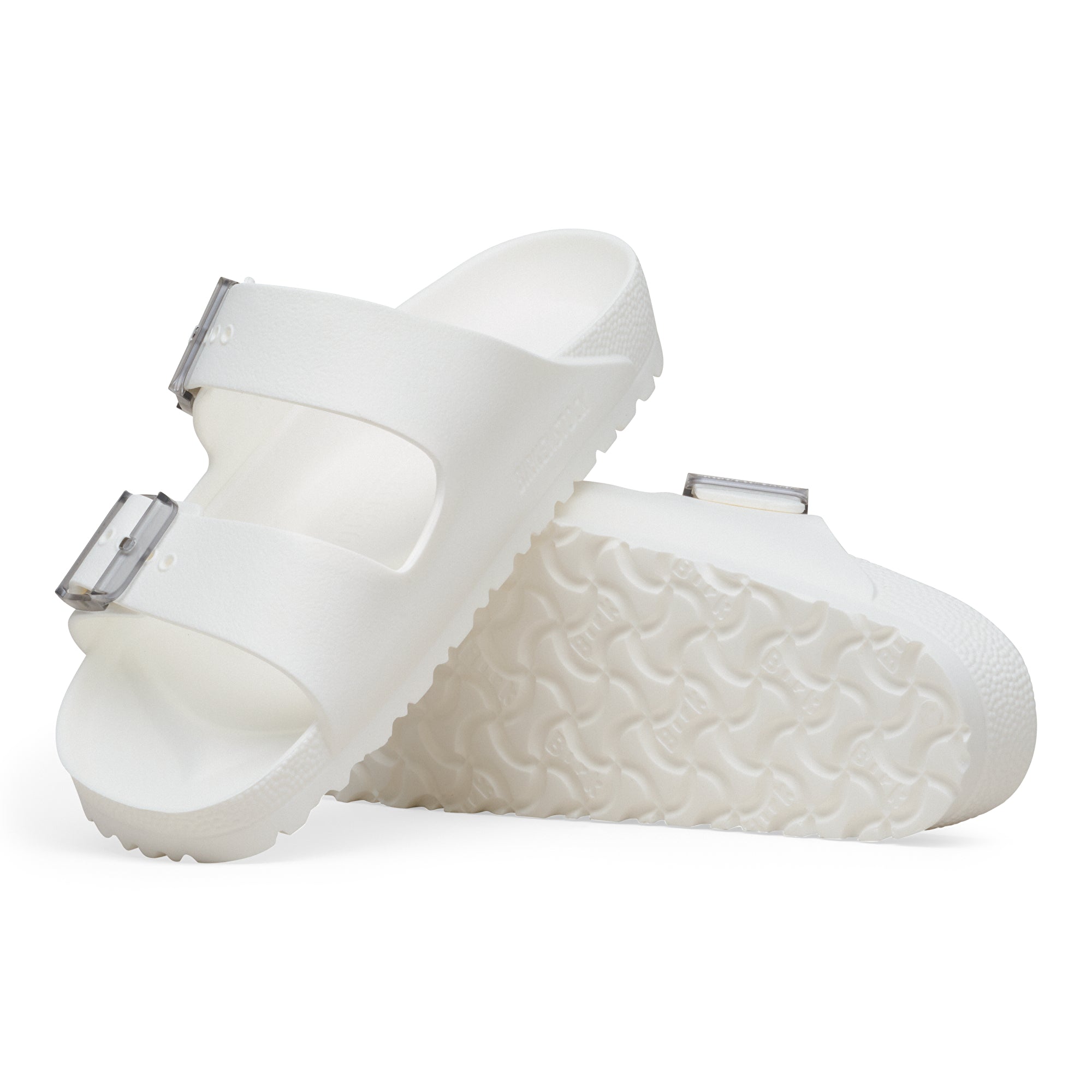 White sandals with metallic straps on a white background