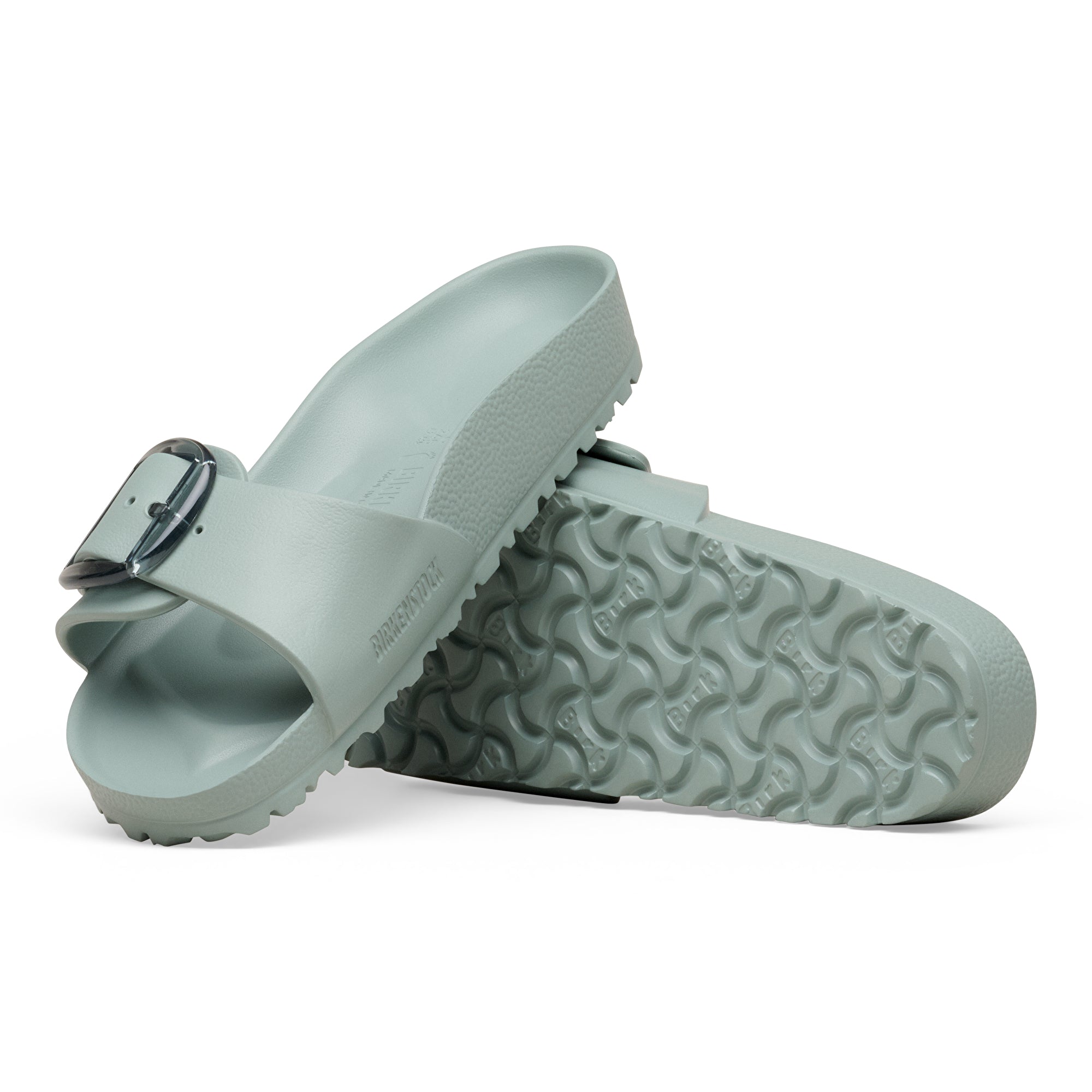 Pair of light gray sandals with a buckle on a white background