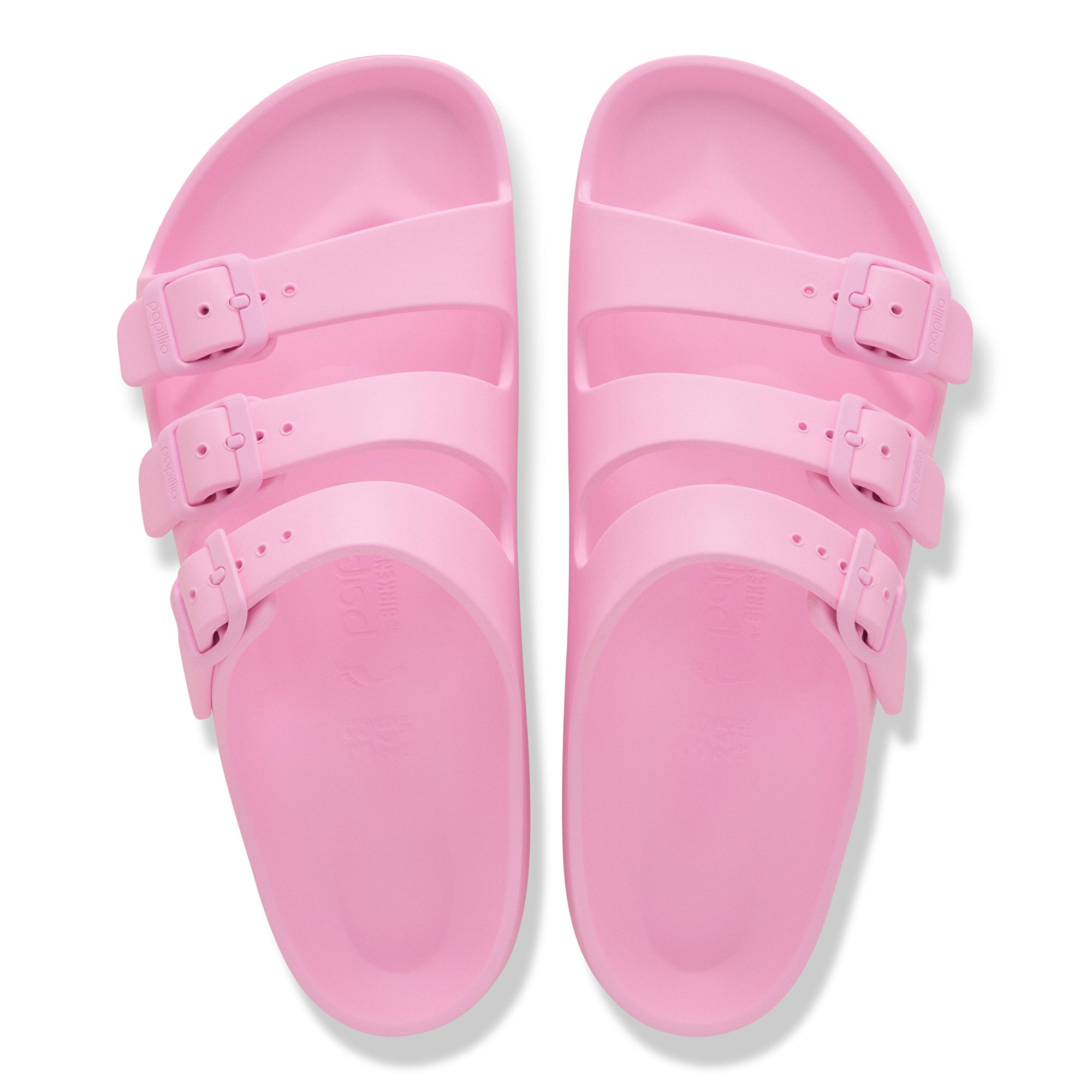 Pink sandals with double straps on a white background