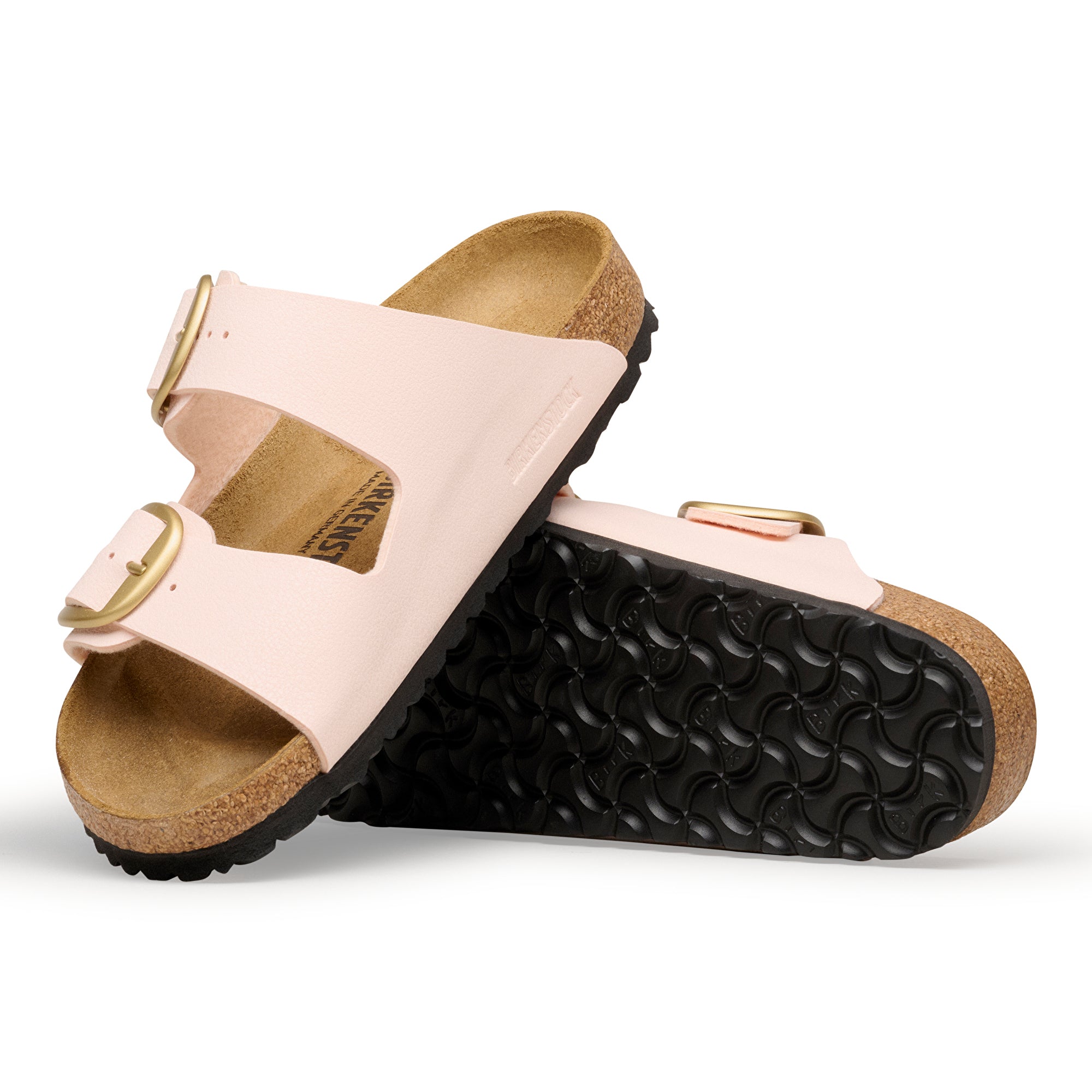 Pair of pink sandals with cork soles on a white background