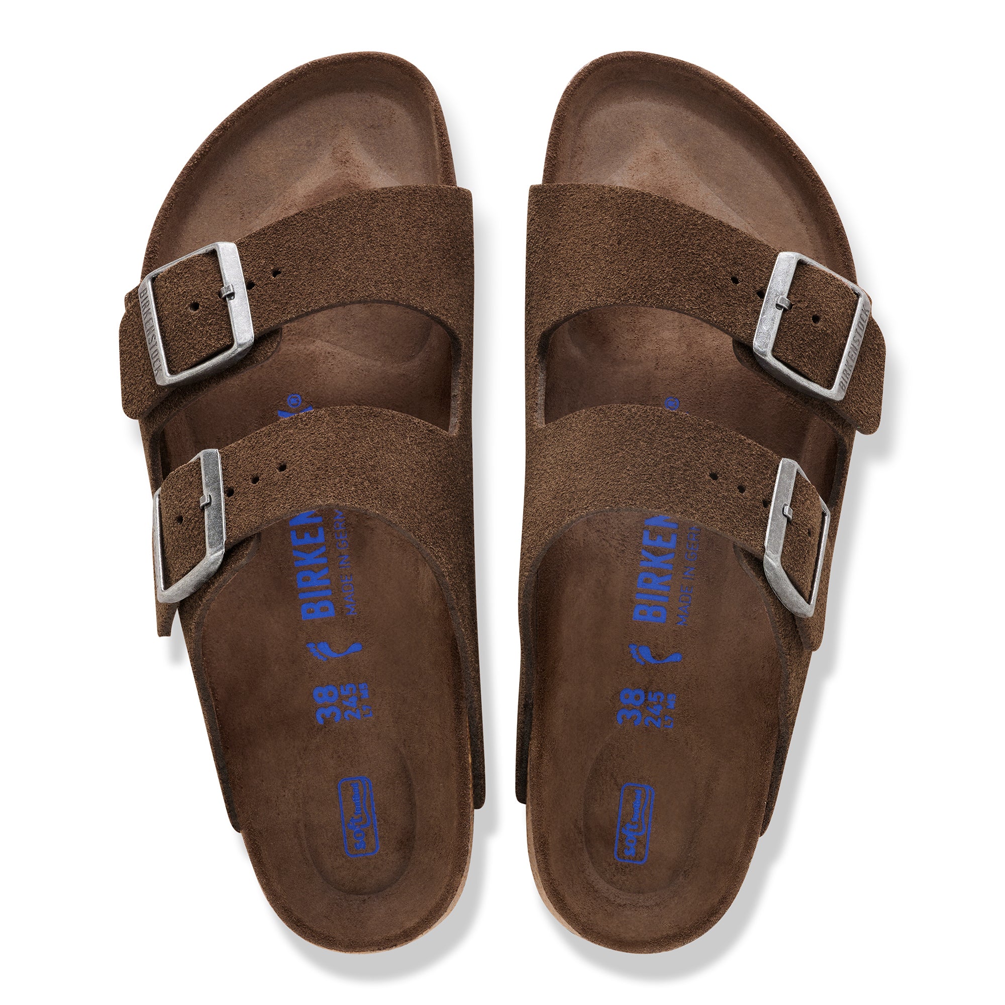 Pair of brown suede sandals with silver buckles on a white background