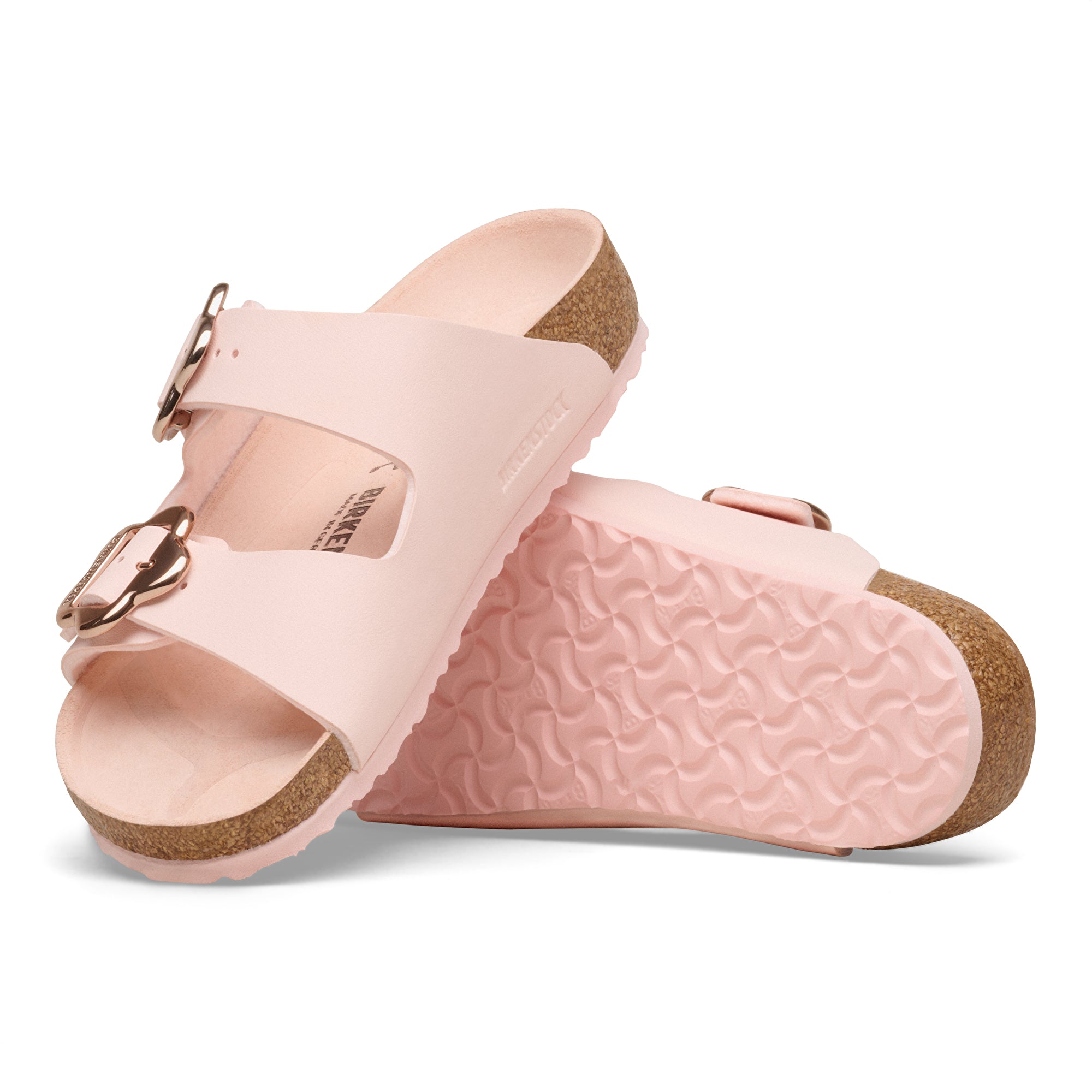 Pair of pink sandals with cork soles on a white background