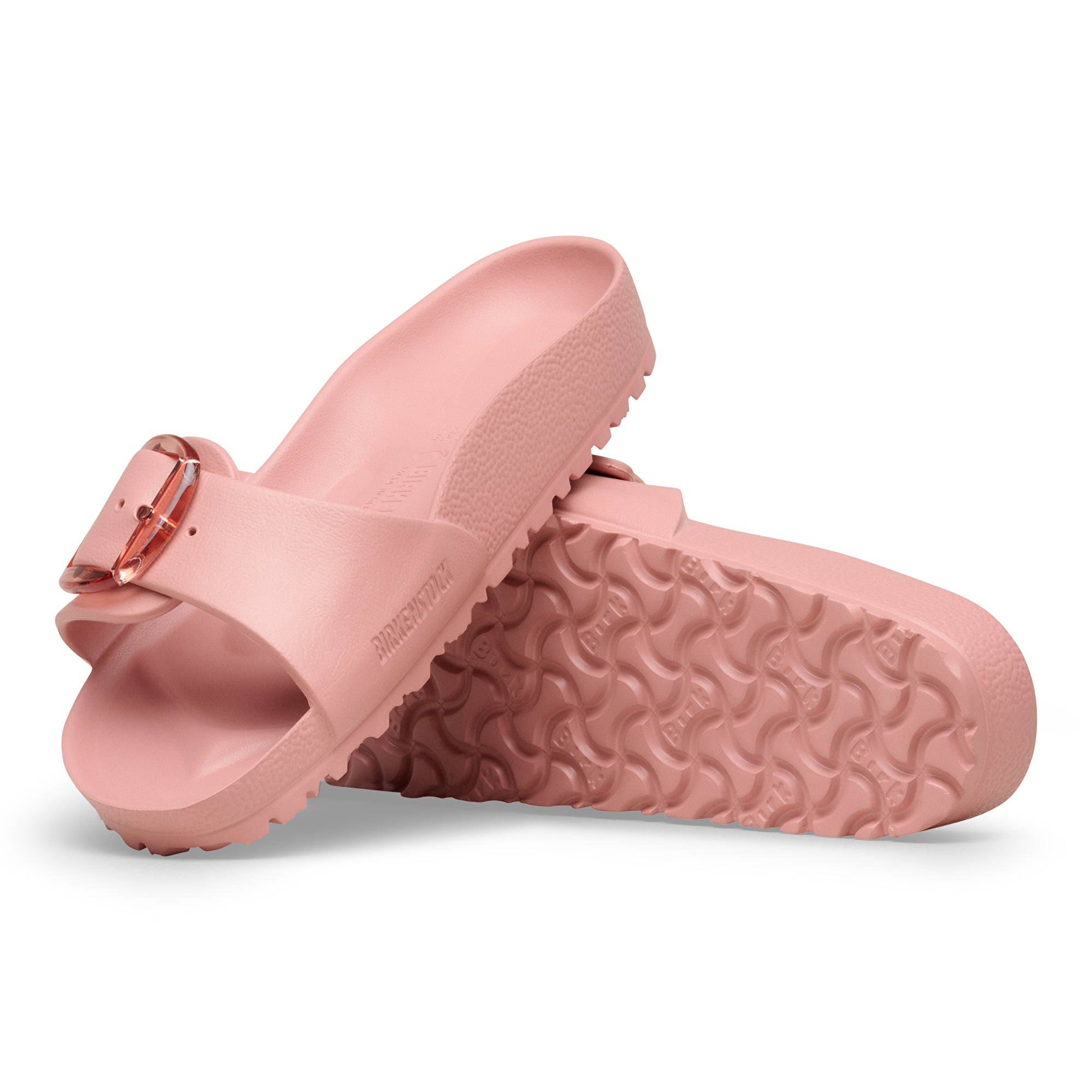 Pair of pink sandals with a buckle on a white background