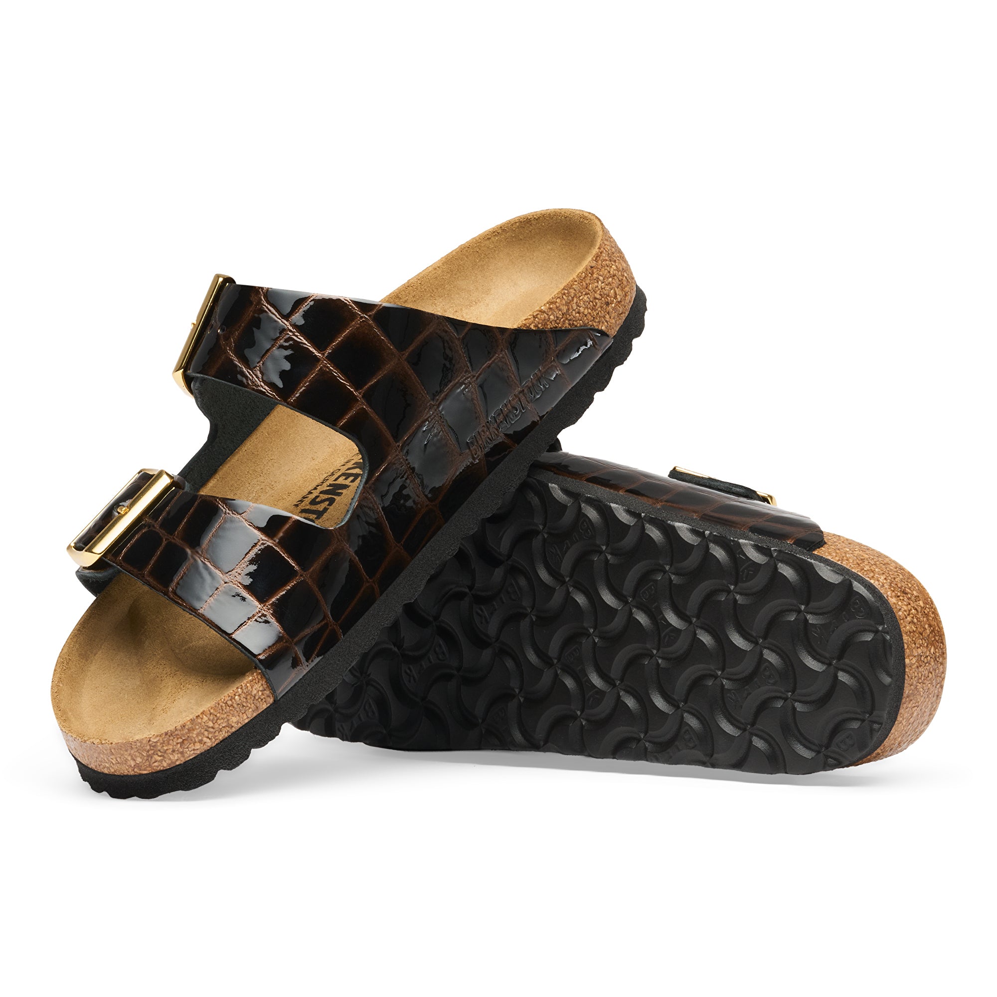 Pair of black crocodile-patterned sandals with cork soles on a white background
