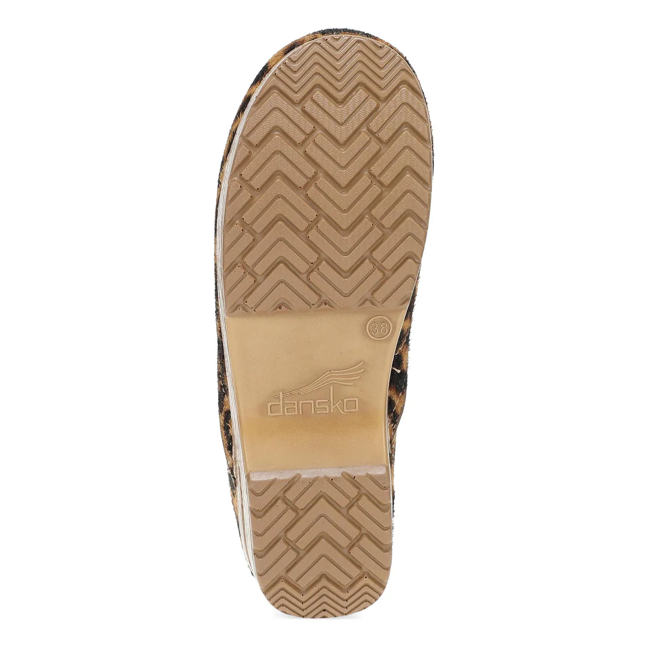 The outsole of a Dansk shoe, showing a tan and brown chevron tread pattern with a beige Dansk brand label in the center, isolated on a white background.