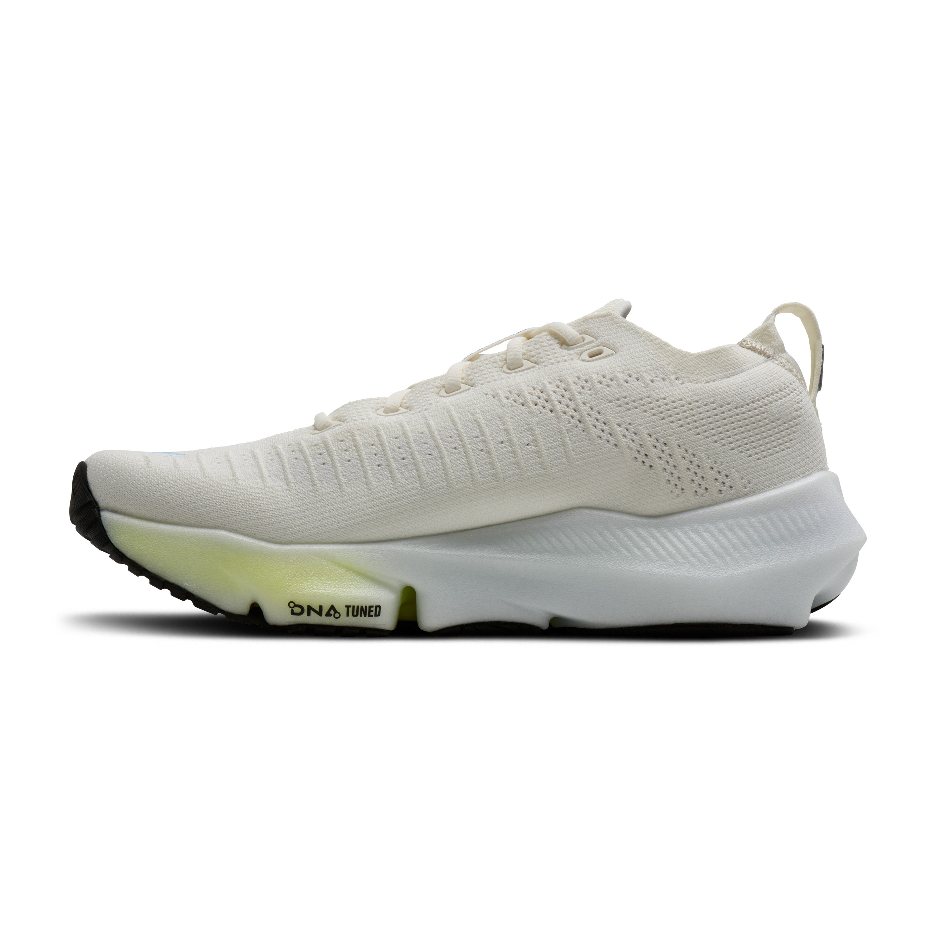White running shoe with green sole on a white background