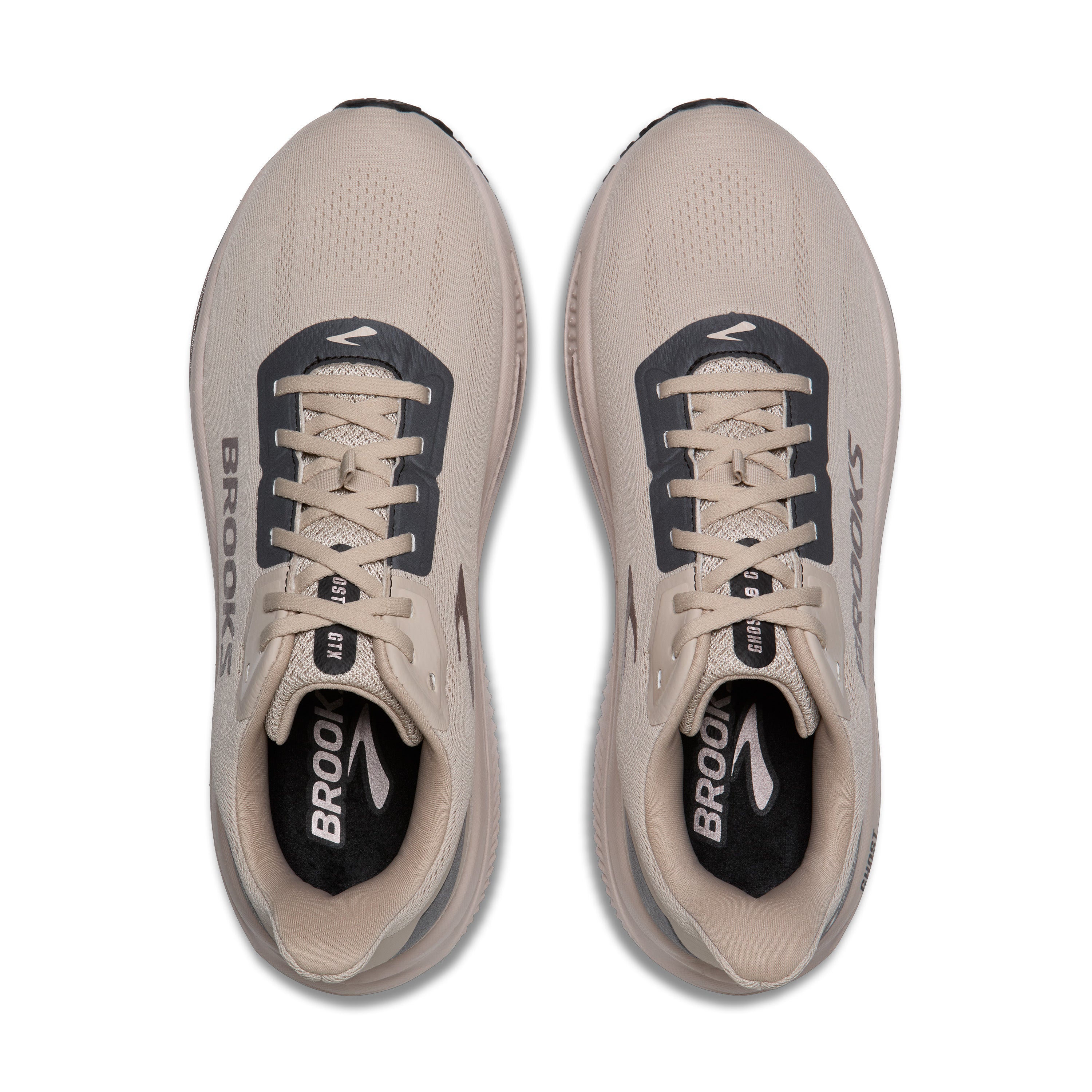 Pair of beige running shoes with 'Brooks' branding on a white background