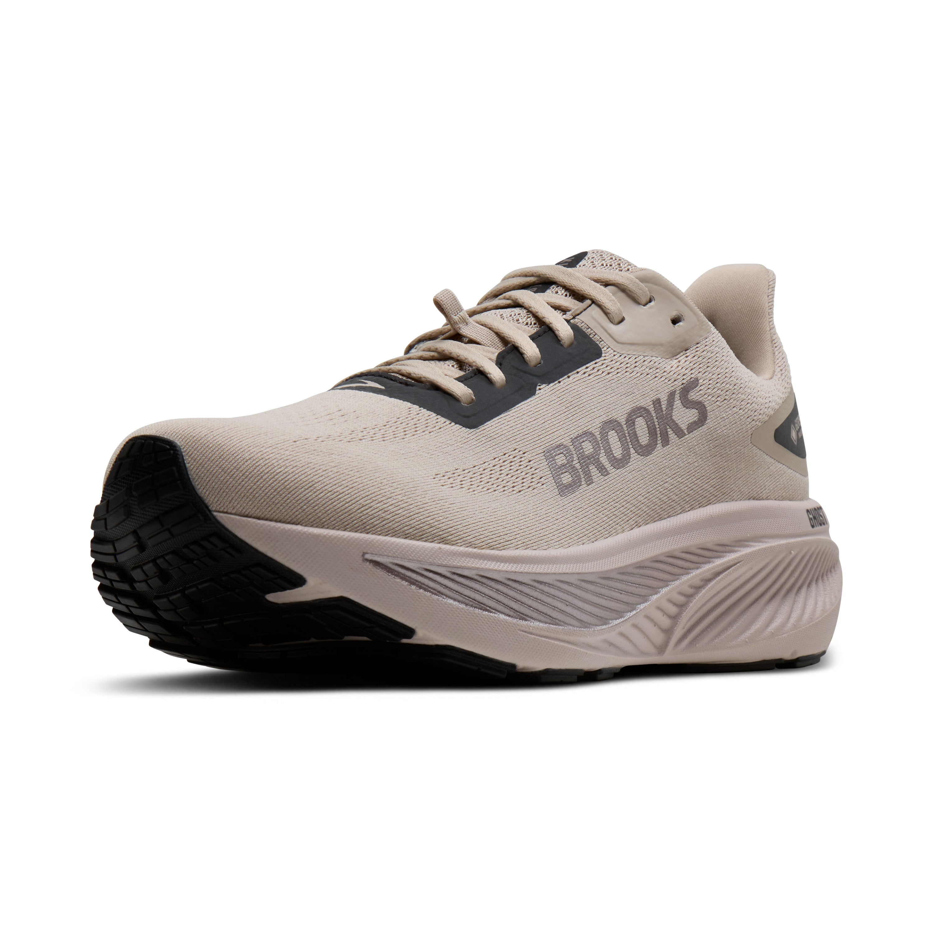 Beige running shoe with black sole on a white background