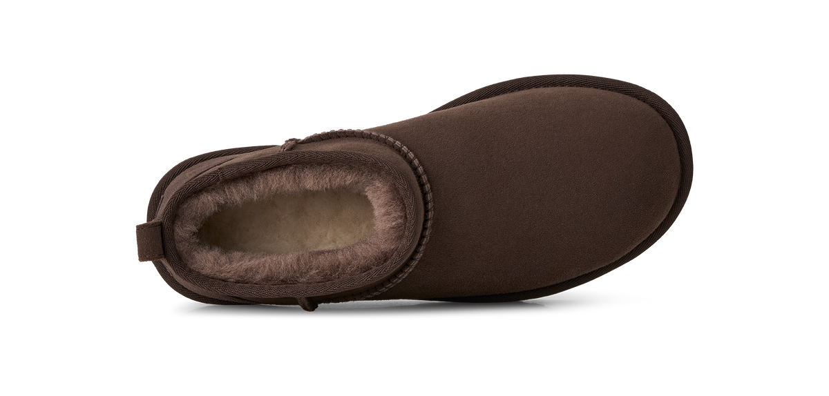 A single brown suede ankle boot with a soft shearling lining, shown from a side profile view on a white background.