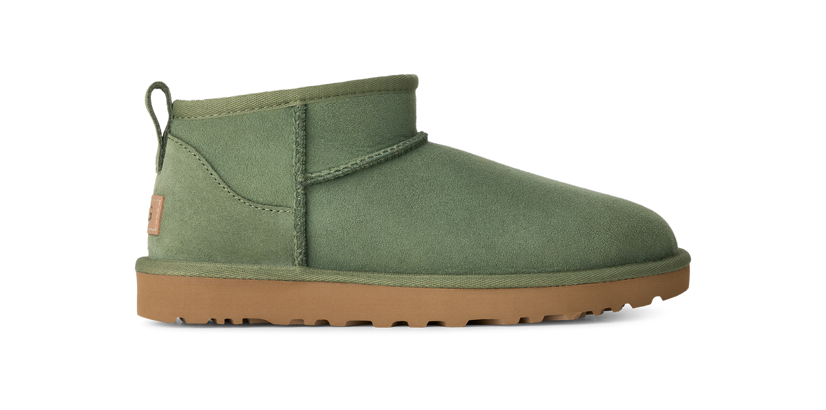 An olive green suede ankle boot with a tan rubber sole, shown in a side profile view against a plain white background.