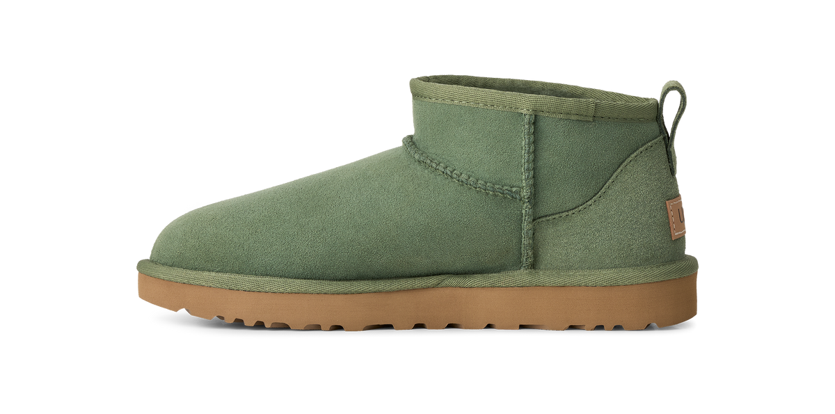 An olive green suede ankle boot with a tan rubber sole, shown in a side profile view against a plain white background.