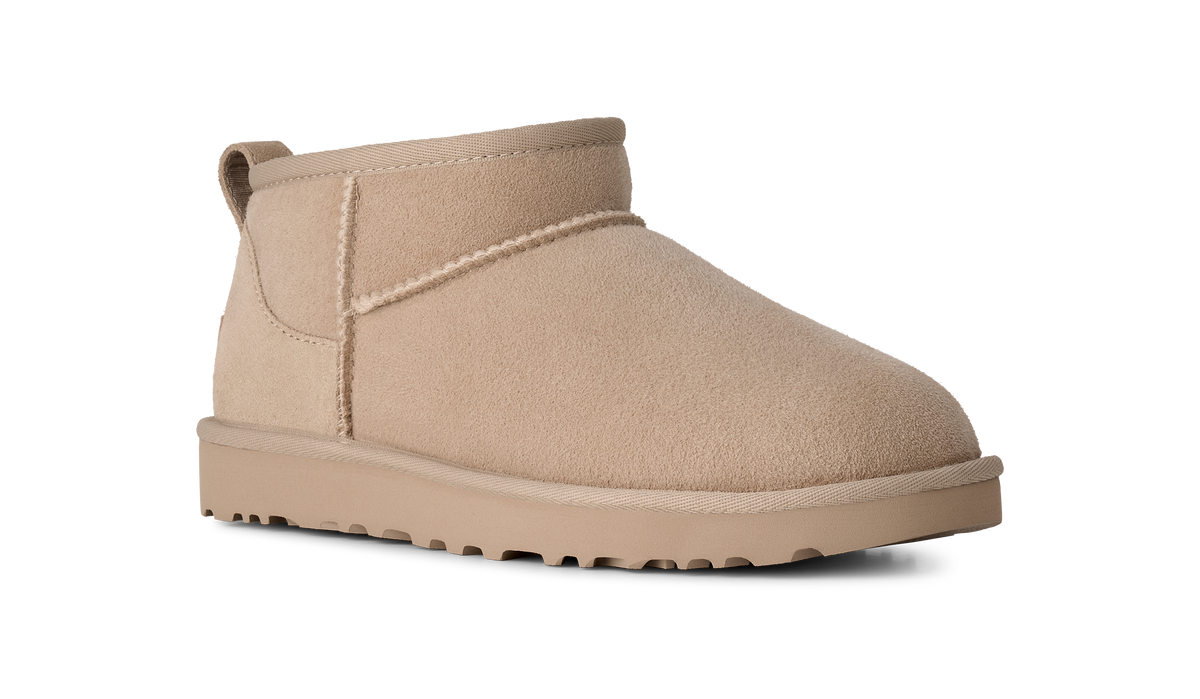 A single beige suede ankle boot with a thick matching sole, shown from a side profile on a white background.