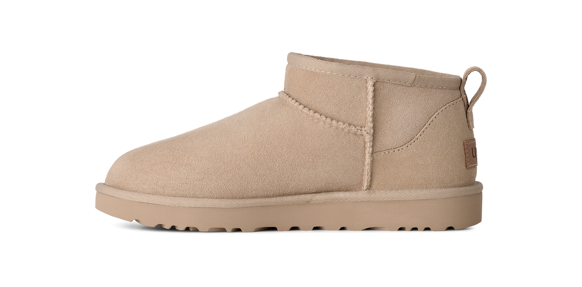 A single beige suede ankle boot shown in a side profile on a solid white background.