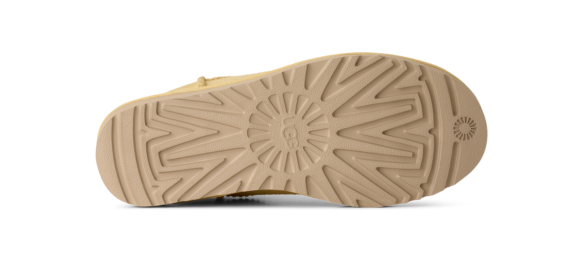 The tan rubber outsole of a boot, shown from a top-down view against a solid white background.