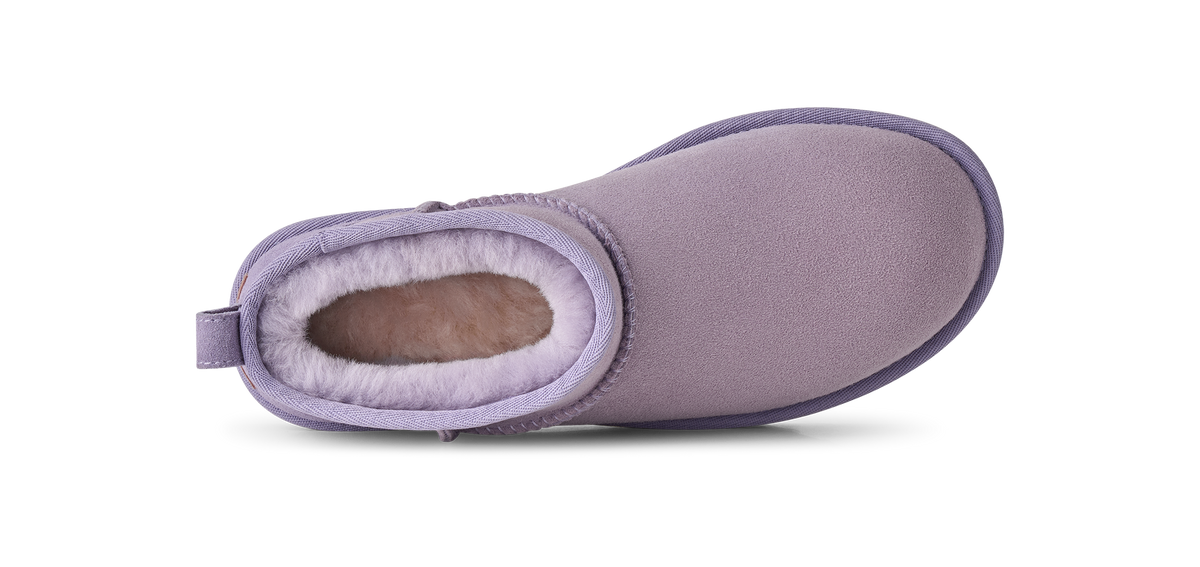 A single light purple slipper boot with a soft fuzzy lining, shown from a side profile view against a white background.