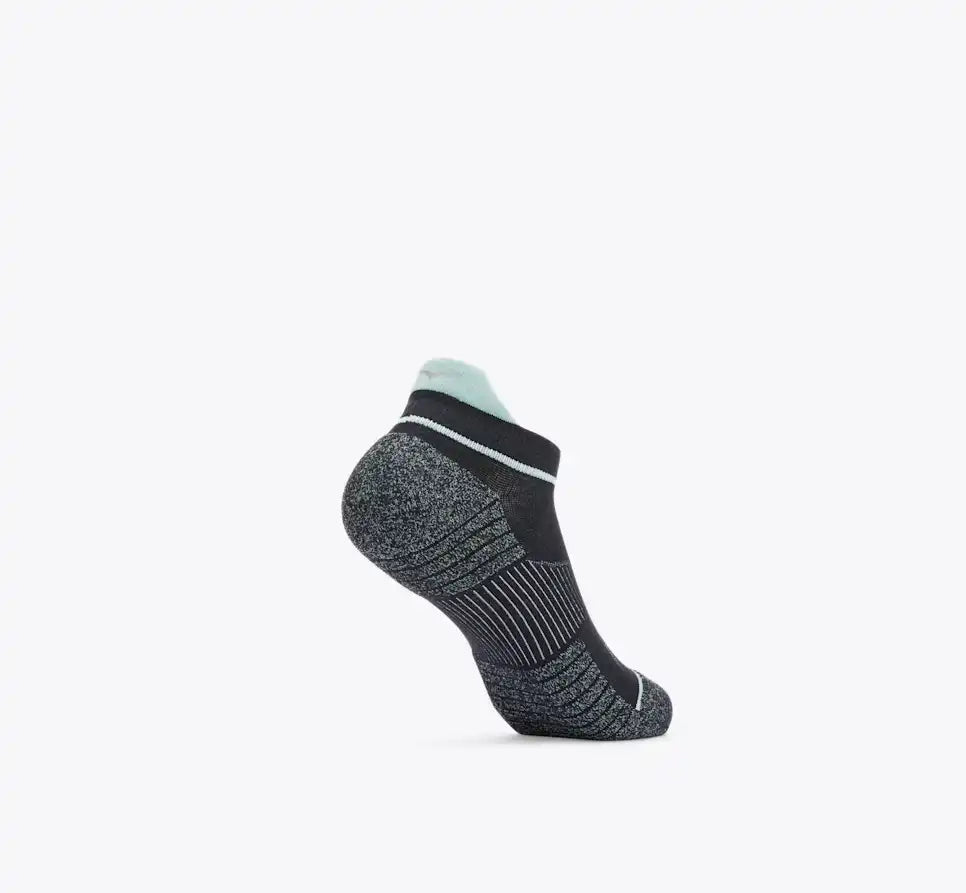 Black ankle sock with white sole on a light gray background