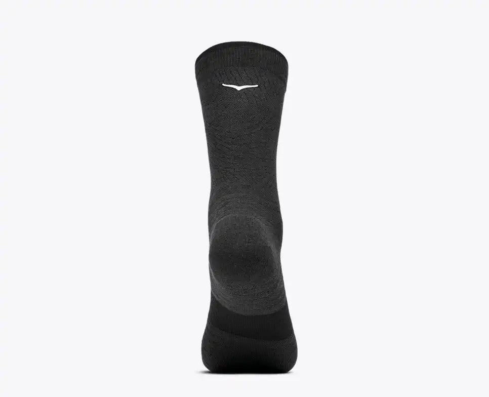A single dark gray crew sock with a small white stylized logo near the cuff, shown against a plain light gray background.