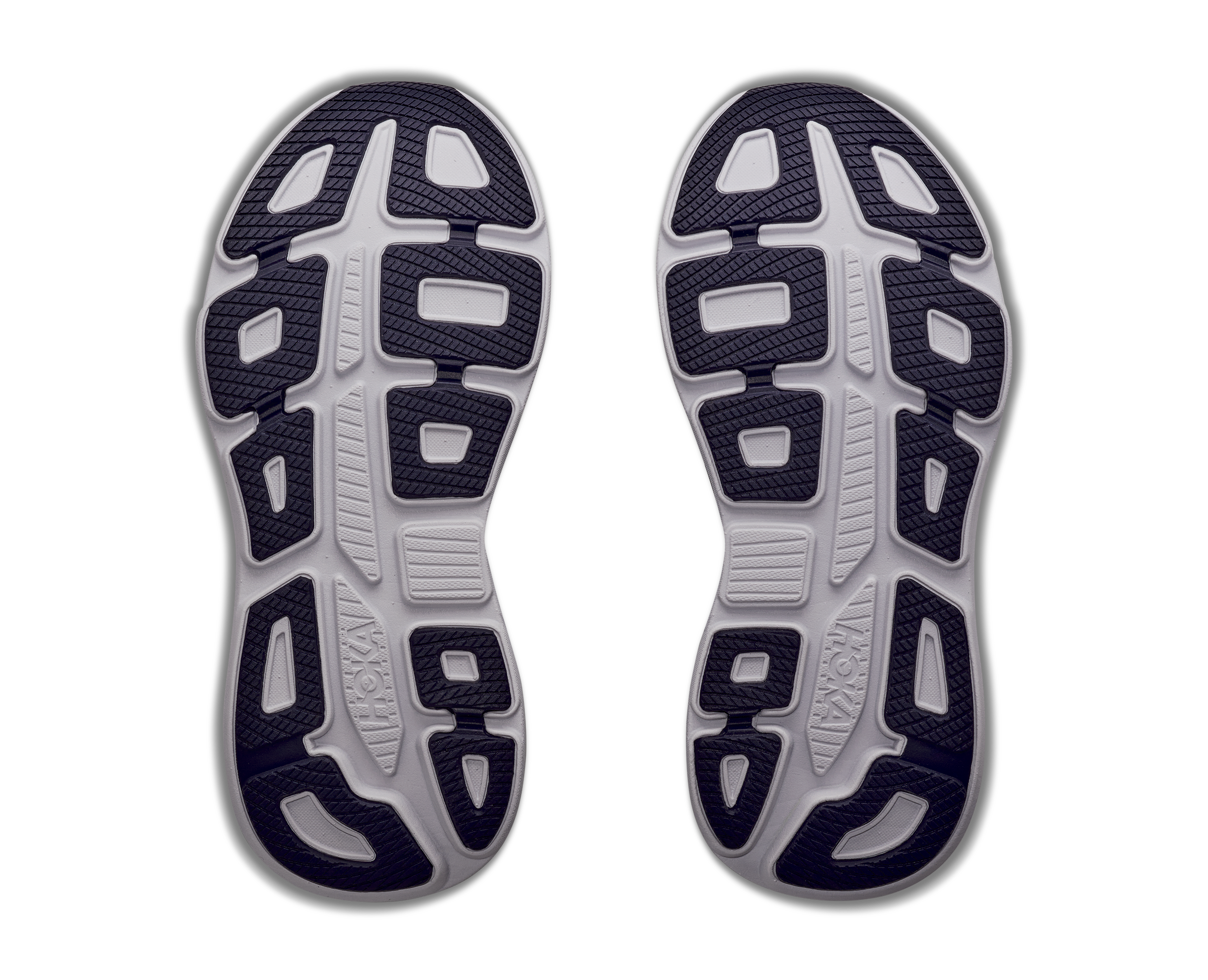 Top view of a pair of running shoes with tread pattern on a white background