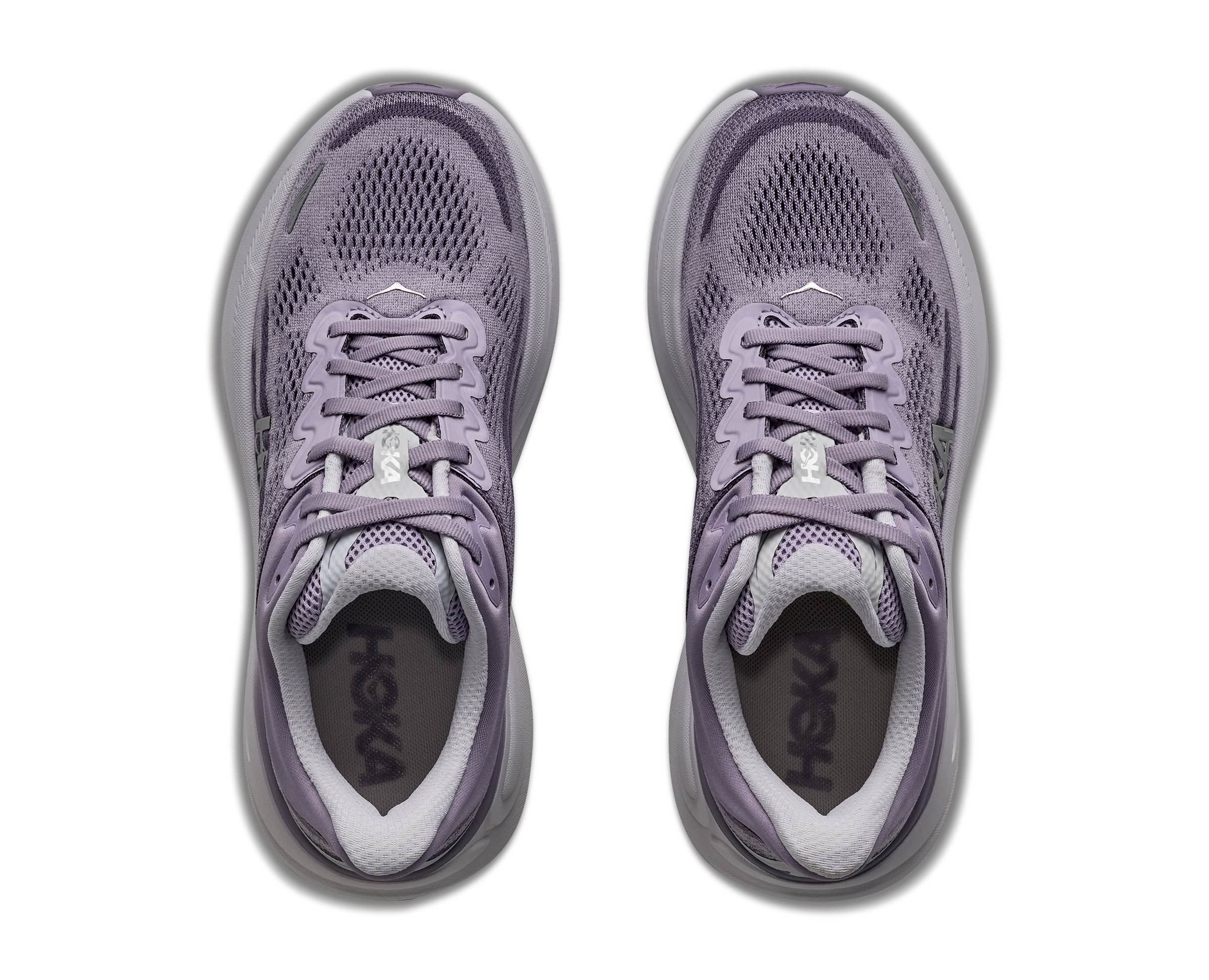 Purple running shoes with white soles on a white background