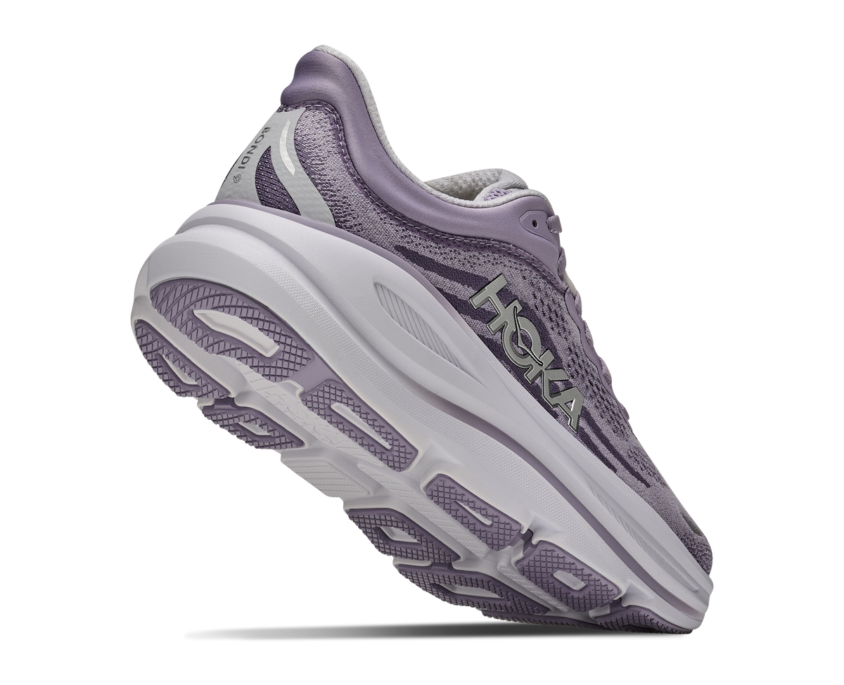 Purple running shoe with white sole on a white background