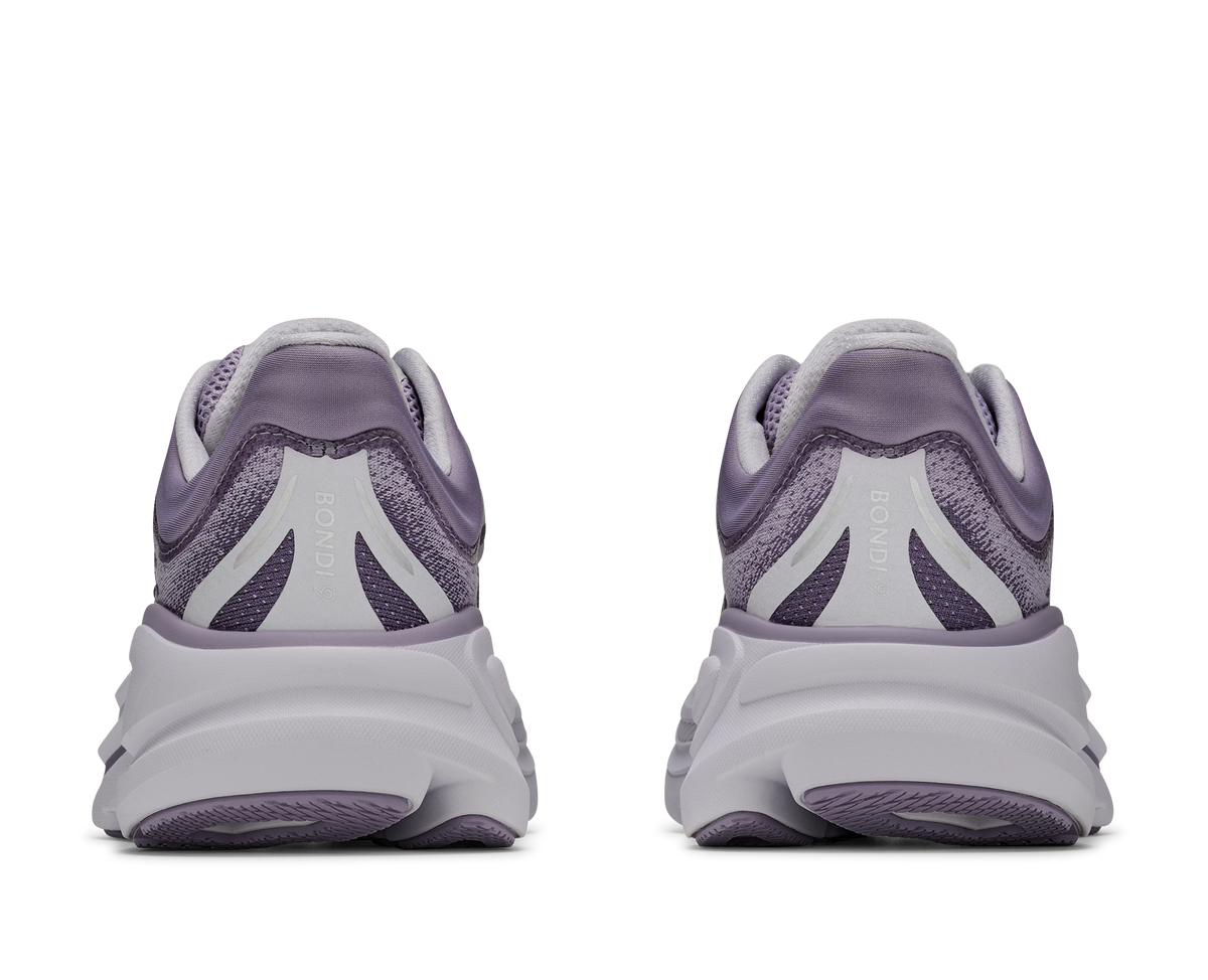 Pair of purple running shoes shown from the back on a white background